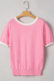 Pink knit top with white contrast trim on neckline and sleeves.