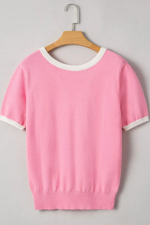 Pink knit top with white contrast trim on neckline and sleeves.