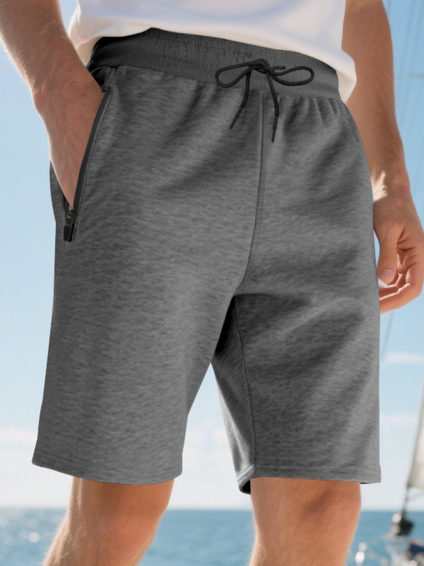 Dark gray casual shorts for men with drawstring and zip pockets.