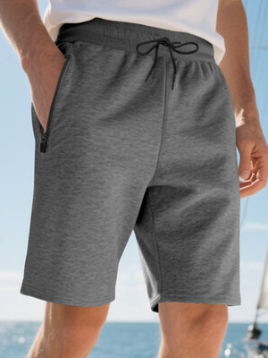Dark gray casual shorts for men with drawstring and zip pockets.