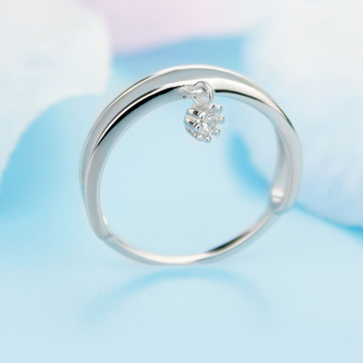 Double layered sterling silver ring with a dangling crystal charm.