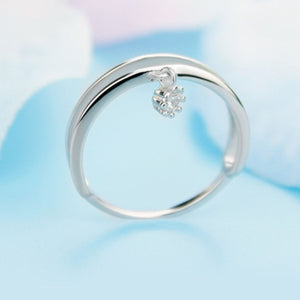 Double layered sterling silver ring with a dangling crystal charm.