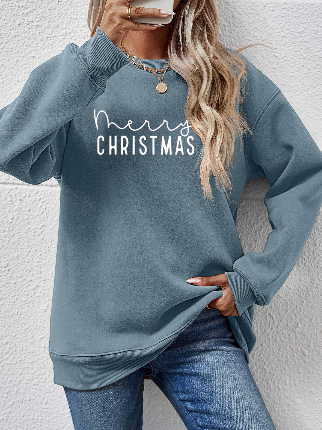 Misty Blue Merry Christmas graphic sweatshirt with crewneck and long sleeves.