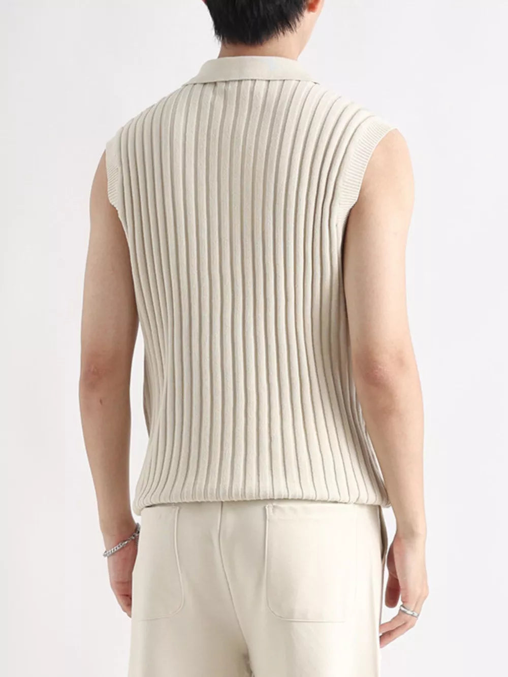 Apricot ribbed knit zip-up tank with collar and sleeveless design.