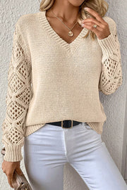 Beige knit sweater with crochet diamond sleeves and V-neck.