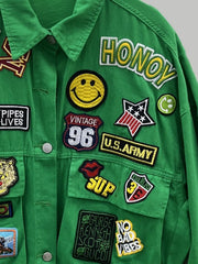 Green denim trucker jacket with embroidered patches including smiley face, U.S. Army, and "HONOY".