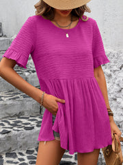 Textured babydoll blouse in magenta with flutter sleeves and a tiered hem.