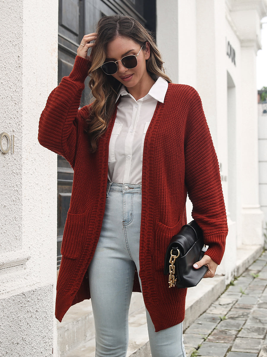 Burgundy ribbed knit cocoon cardigan with pockets and long sleeves.
