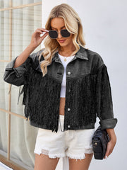 Black denim trucker jacket with fringe trim and button front, styled with white shorts.