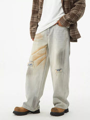 Distressed light wash wide-leg jeans with unique patches and a relaxed fit.