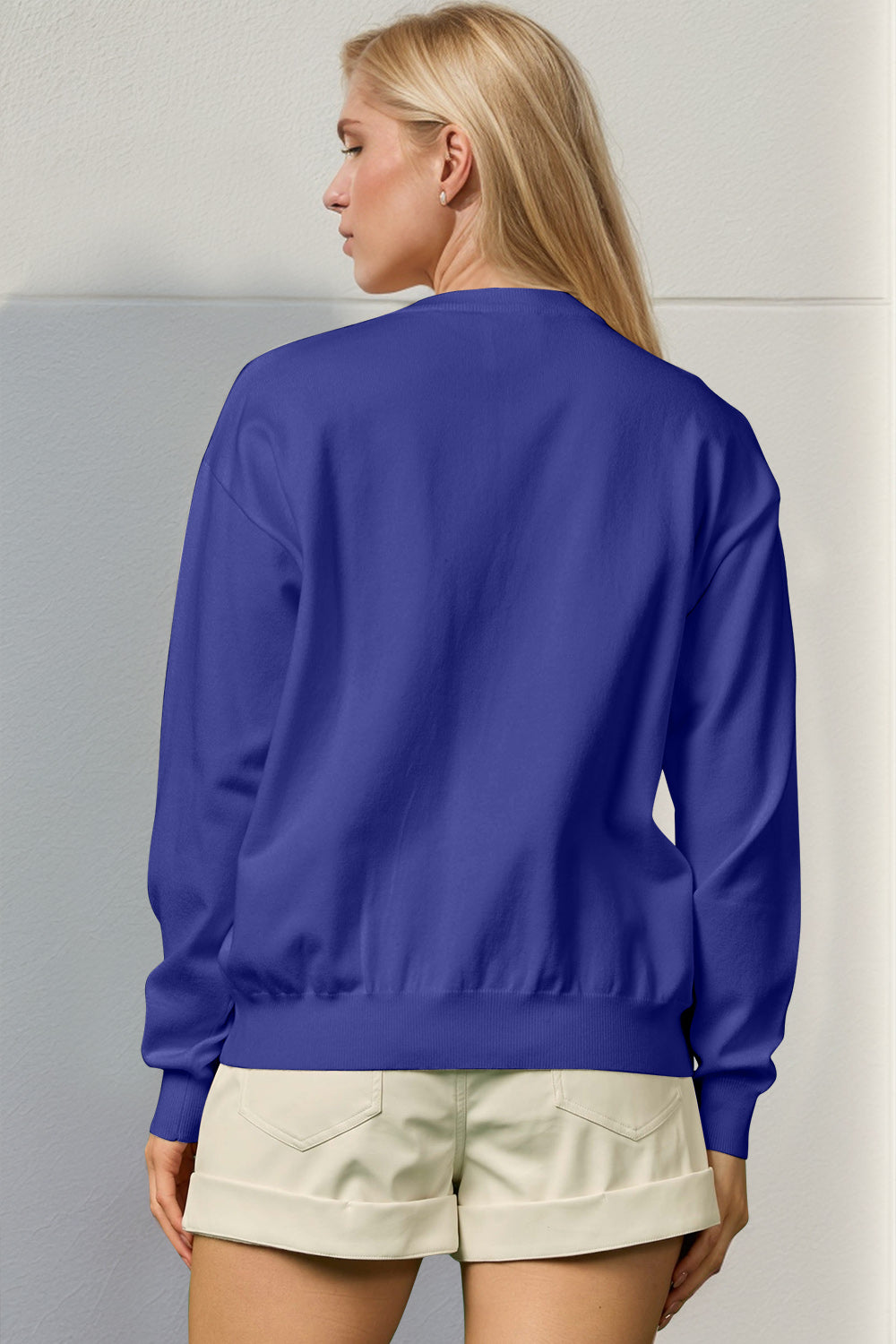 Royal blue crewneck sweater with ribbed cuffs and hem, 100% polyester.