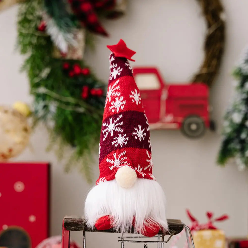 Red knit gnome with snowflake pattern and white beard, topped with a red star.