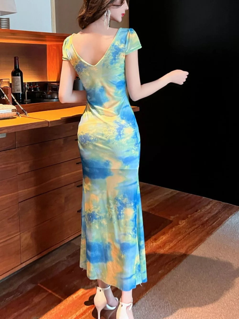 Surplice ruffle maxi dress in blue and yellow tie-dye with short sleeves.