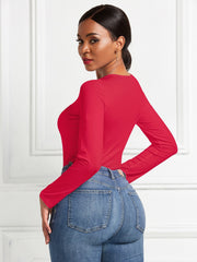 Red long sleeve ribbed bodysuit with a crew neck, paired with blue jeans.