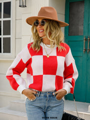 Checkerboard knit pullover sweater with balloon sleeves in red and white.