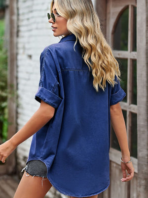 Relaxed denim shirt jacket in medium blue with cuffed short sleeves and a collar.