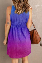 Sundress with ombre blue to purple gradient, elastic waist, and button front detail.