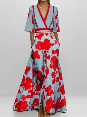 Vibrant floral maxi dress with pockets in light blue and red, featuring a V-neck and flutter sleeves.