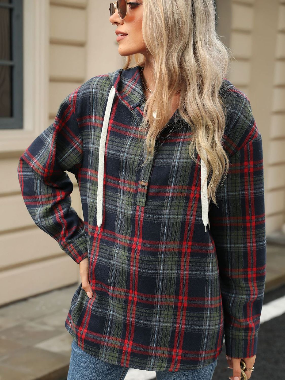 Plaid henley hooded shirt in dark navy, red, and green with white drawstrings and a buttoned placket.