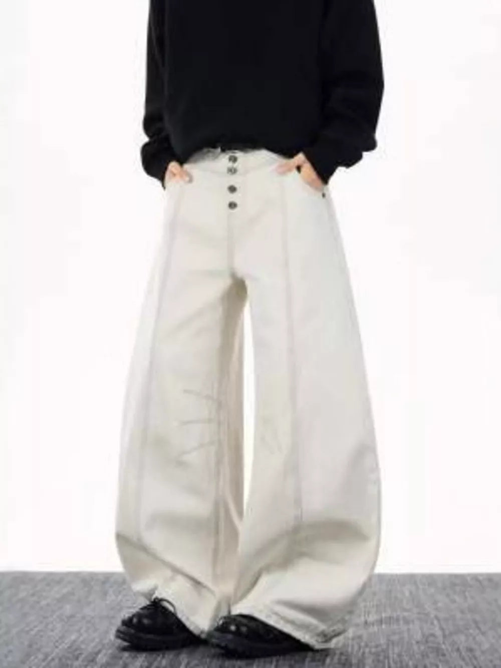 Relaxed fit wide leg button fly jeans in off-white cotton with front seams and button closure.