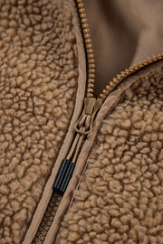 Sherpa-lined hooded jacket in brown with contrast lining and zipper detail.