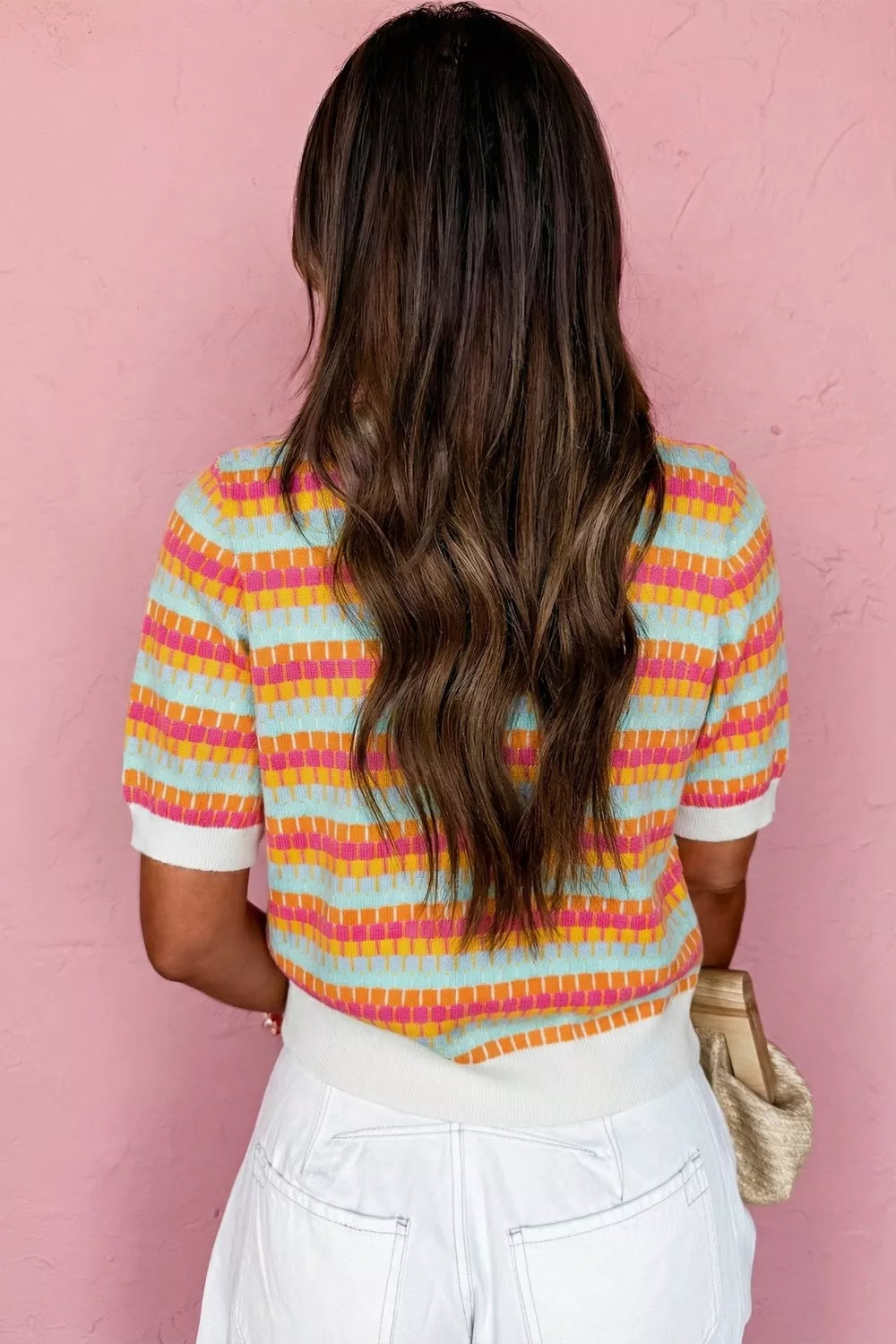 Vibrant abstract knit sweater with short sleeves and ribbed trim in colorful stripes.