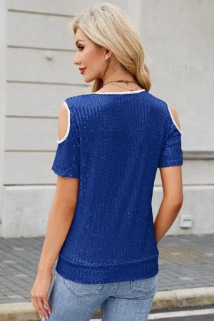 Royal blue sequin cold shoulder blouse with white trim and short sleeves.