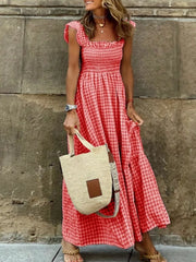 Red gingham ruffled maxi maternity dress with square neckline and smocked bodice.