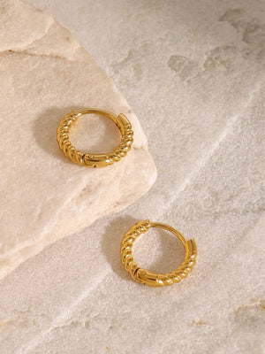 Gold twisted mini hoop earrings with a textured design.