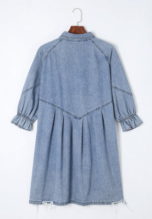 Light blue denim shirtdress with ruffled cuffs, A-line cut, and frayed hem.