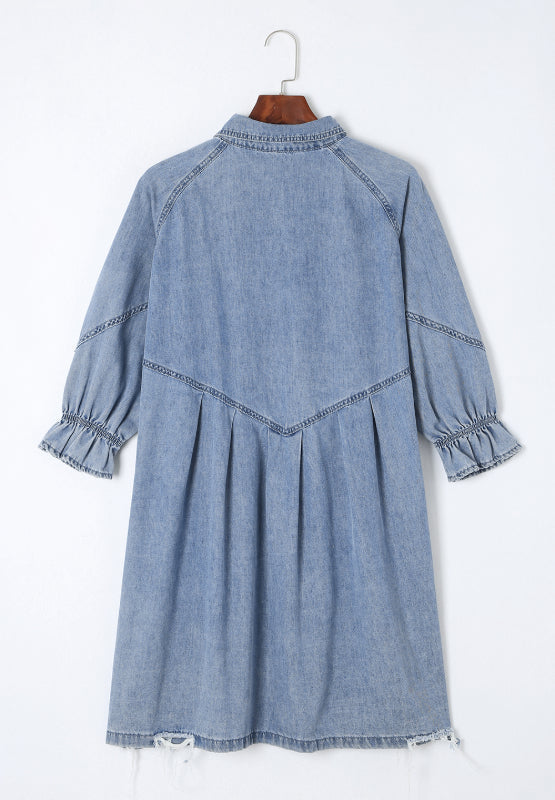 Light blue denim shirtdress with ruffled cuffs, A-line cut, and frayed hem.