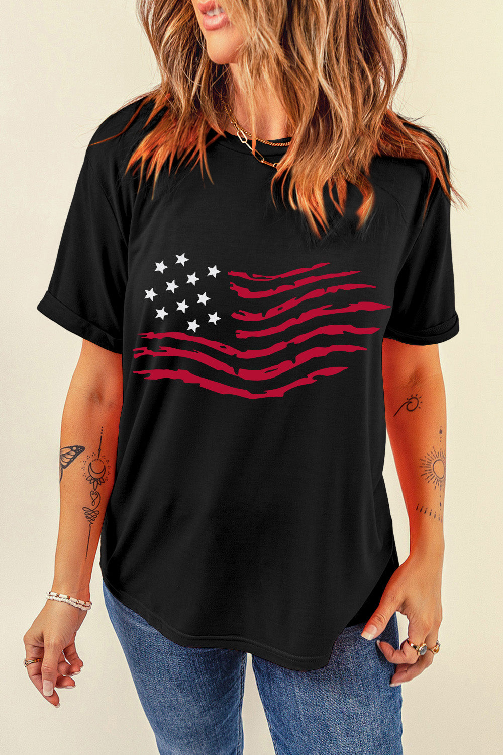 Black t-shirt with distressed American flag graphic and rolled sleeves.