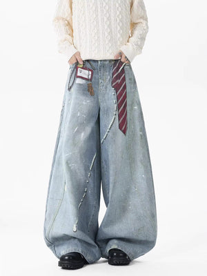 Oversized denim jeans with pearl accents and paint splatters, featuring a tie detail.