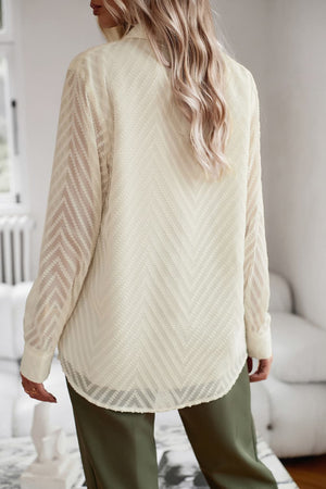 Ivory textured chevron button-down blouse with sheer sleeves.