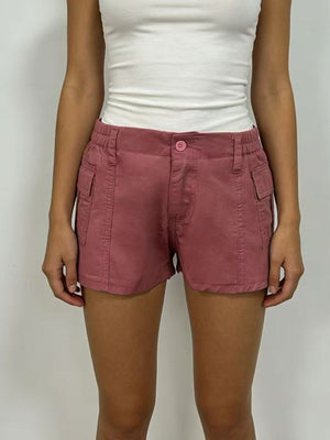 Pink cargo shorts with button closure and side pockets.