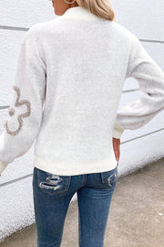 White textured knit zip-neck pullover sweater with floral detail on sleeve