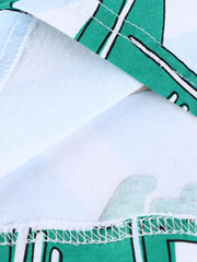 Toddler t-shirt with green construction vehicle print, white cotton, and zigzag hem detail.