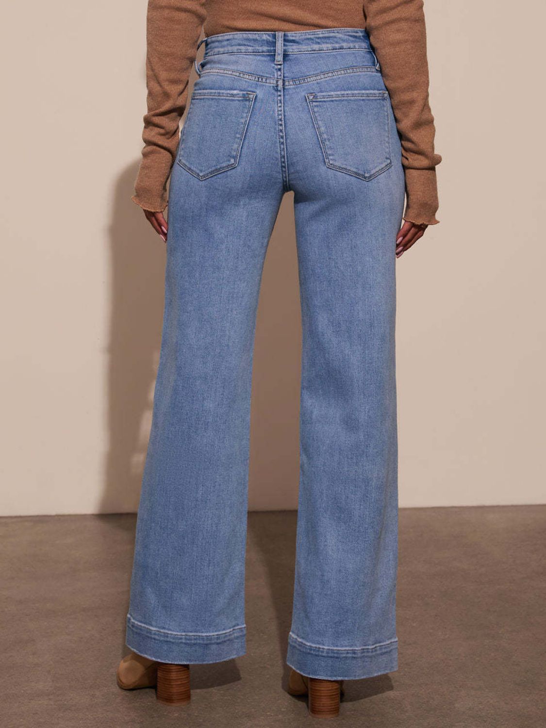 Sailor-inspired wide leg jeans in light wash denim with a flared hem.