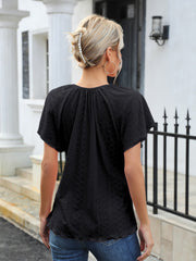 Black perforated tie-neck flutter sleeve blouse with a ruffled hem