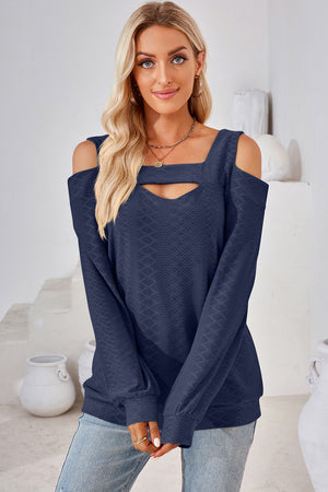 Dark blue textured top with cutout neckline and cold shoulder long sleeves.