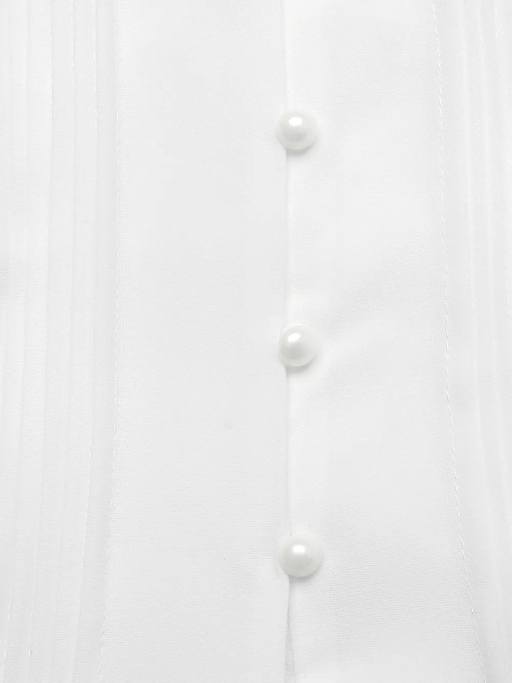White midi dress with cap sleeves, pearl buttons, and pintuck detail.