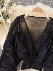 Black ruched sleeve blouse with deep V-neck and smocked waist