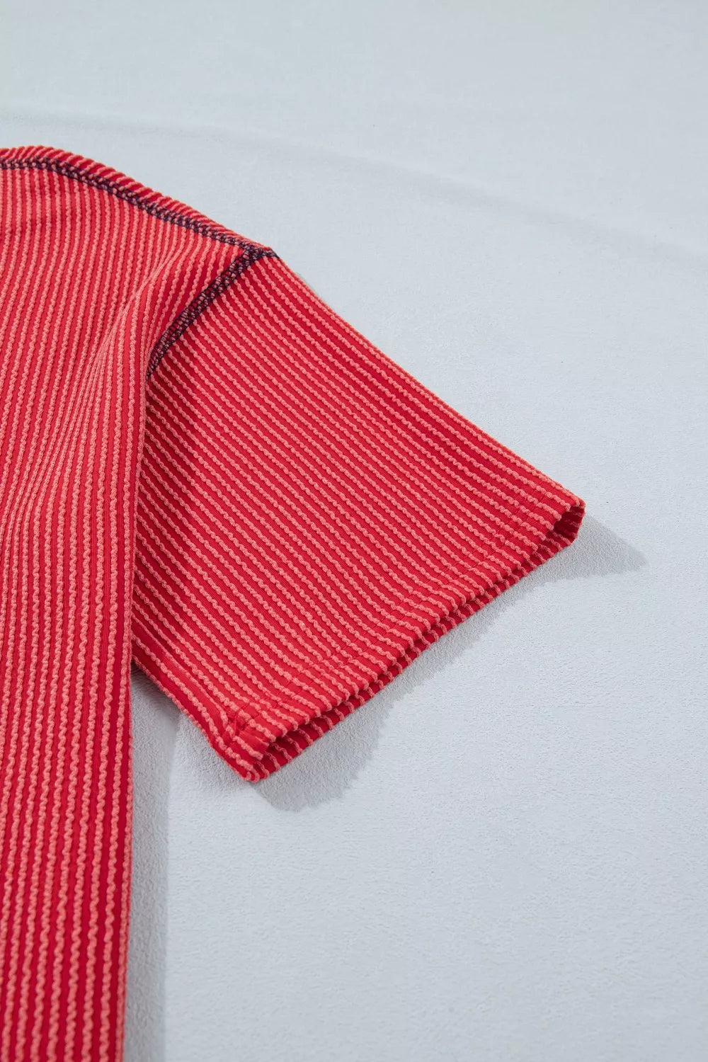 Red striped twisted rib t-shirt with crew neck and short sleeves.