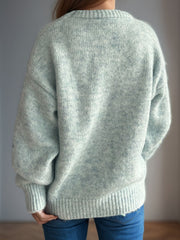 Light green oversized crewneck sweater with textured knit and ribbed cuffs and hem.