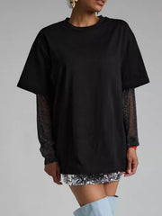Black oversized t-shirt with sheer glitter sleeves and a crew neck.