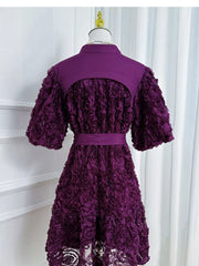 Purple floral textured puff sleeve dress with button detail and belted waist.