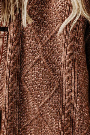 Brown cable knit sweater dress with diamond pattern and braided details.