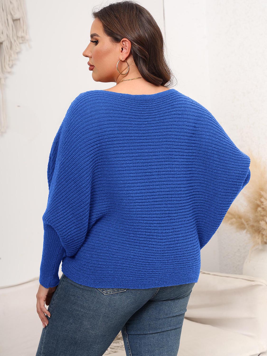 Royal blue ribbed knit off-shoulder sweater with batwing sleeves.