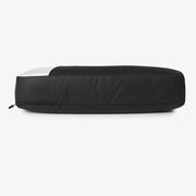 Modern color block travel bag in black with a white accent panel and zipper detail.