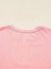 Dusty pink oversized sweatshirt with contrast stitching detail at the neckline.